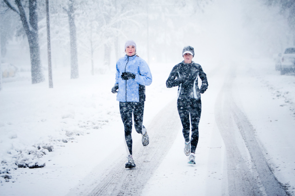 Two women run down Mountain Avenue in a snowstorm.